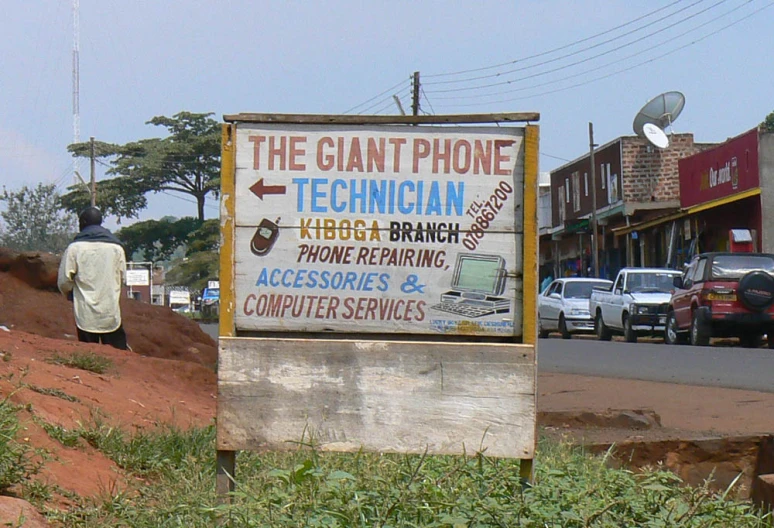 the sign for the giant phone technician on a rural side road