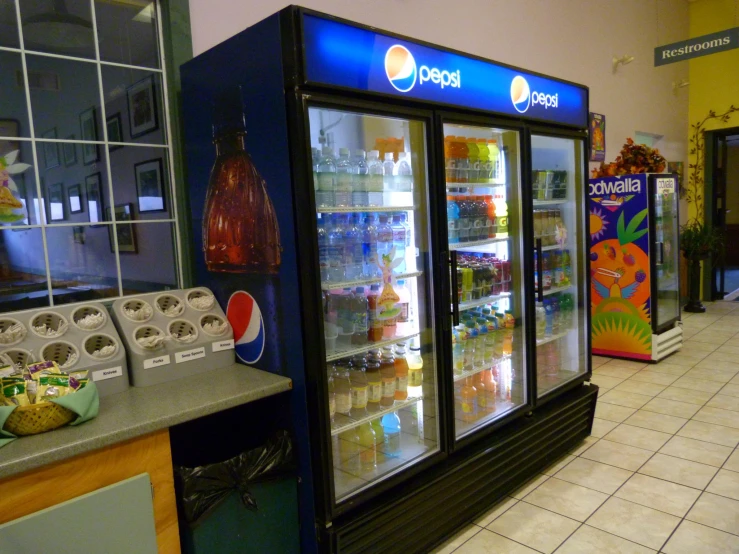 a food and drink section with shelves filled with ice cream and fruit