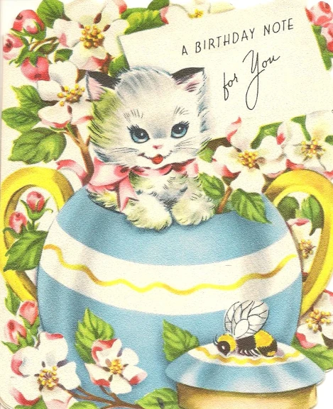 a kitten in a tea pot on a birthday card