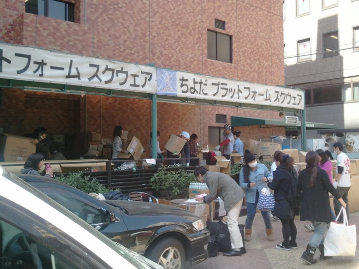 people are waiting at an outside food truck