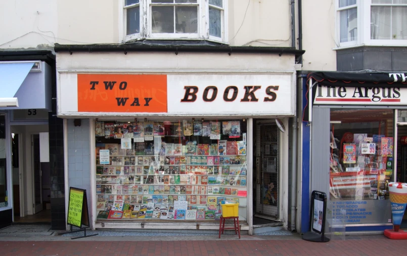 an orange and black sign is on a store