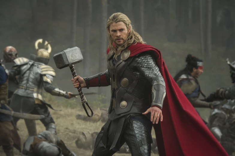 thor thor is standing next to a bunch of people