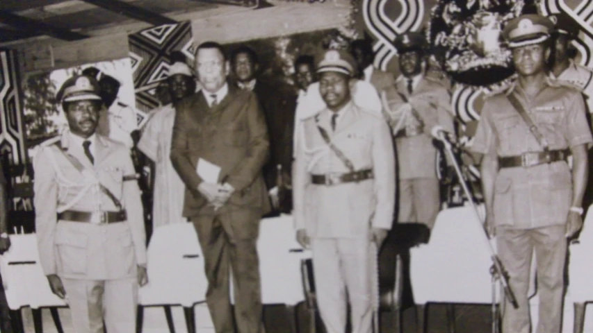 four uniformed men and one officer standing together