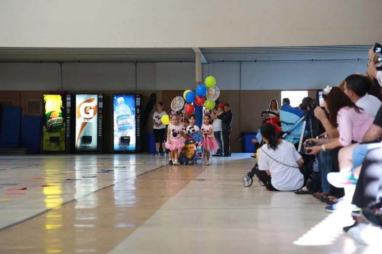 people looking down the runway at a child's fashion show