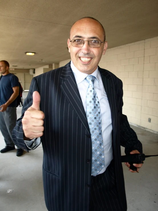 a business man with a thumbs up, on an airport
