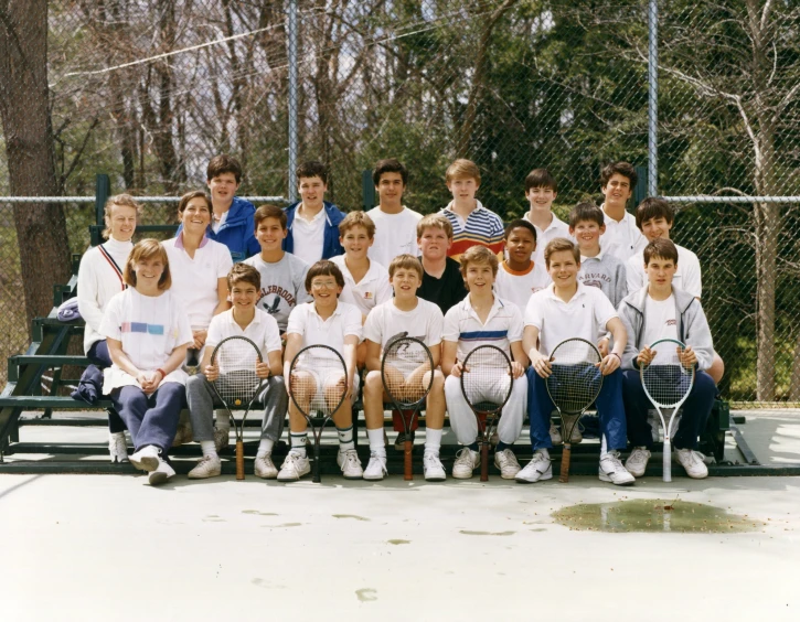 tennis team posing for po with racquets