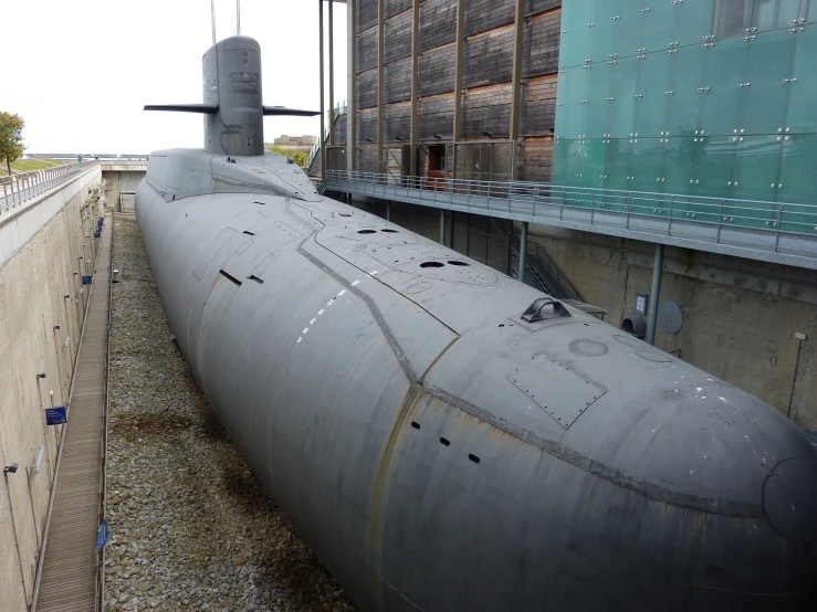 an old military submarine is shown in an industrial area