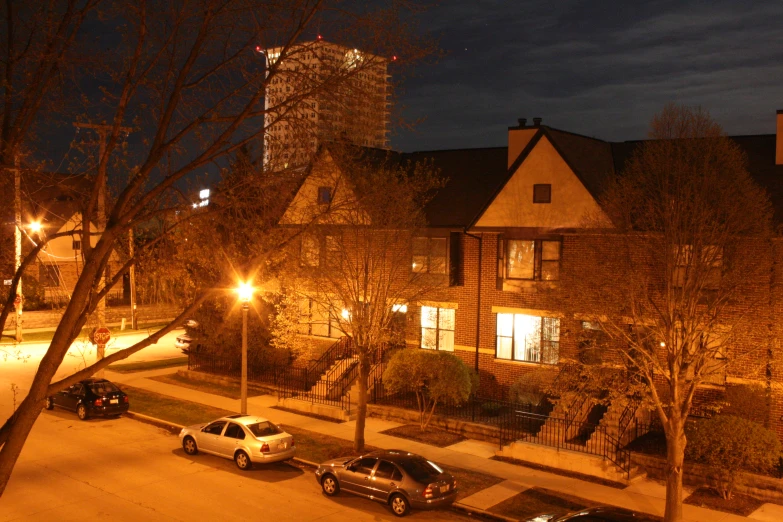 a house at night with cars parked outside