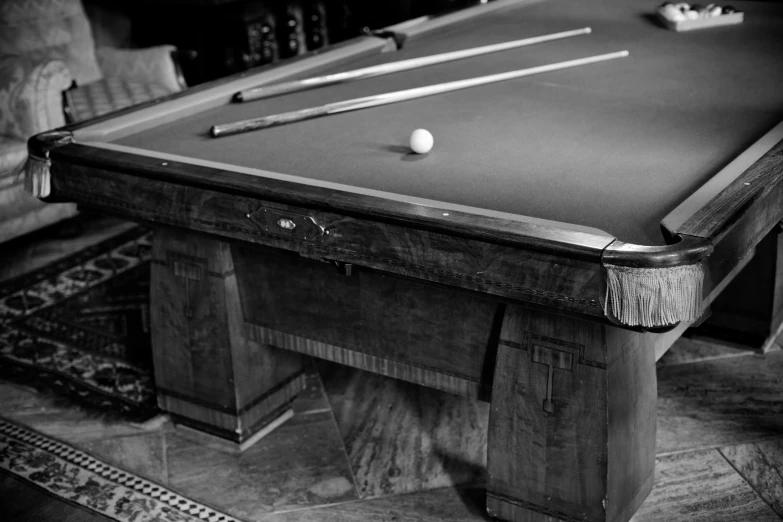 a pool table sitting in the middle of a living room