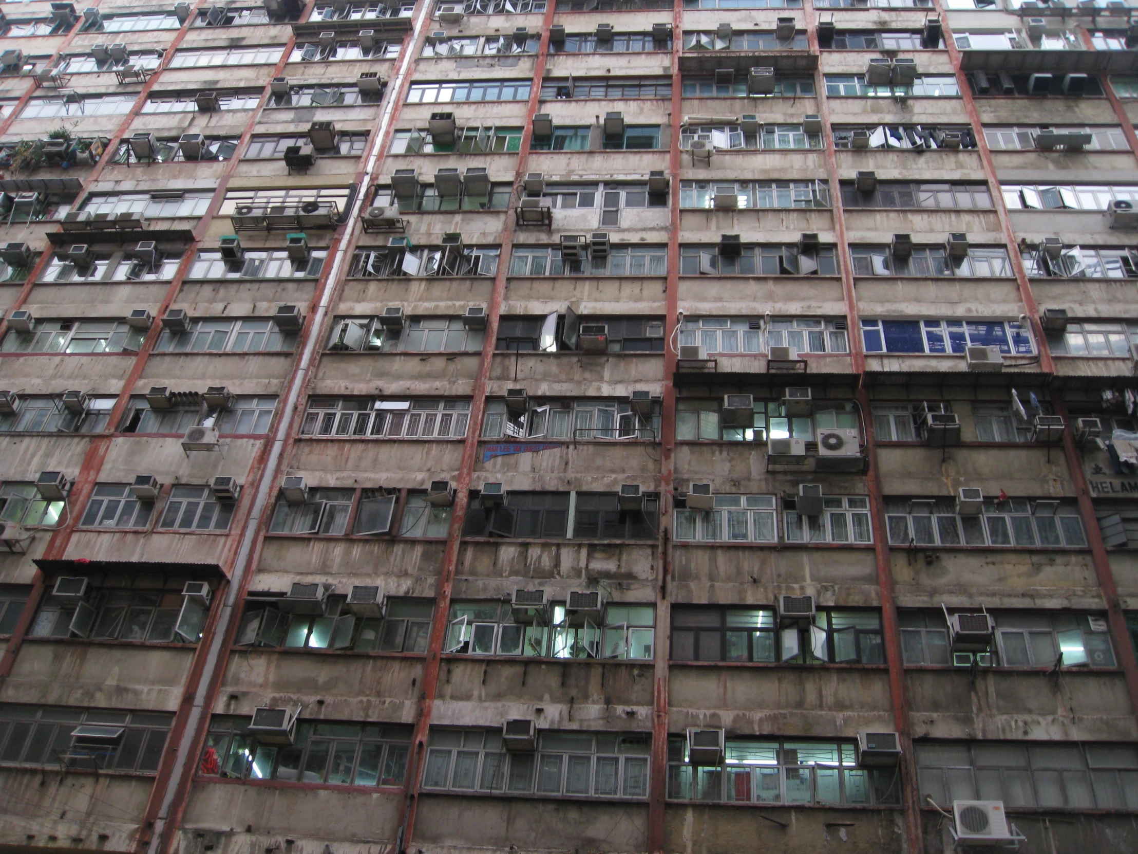 an old building with lots of windows and red piping