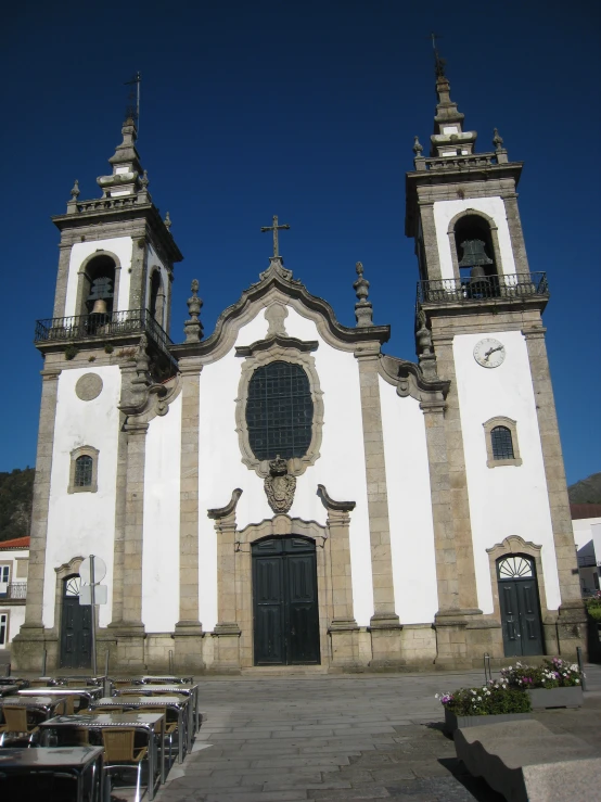 large white church with stone steps and two black doors