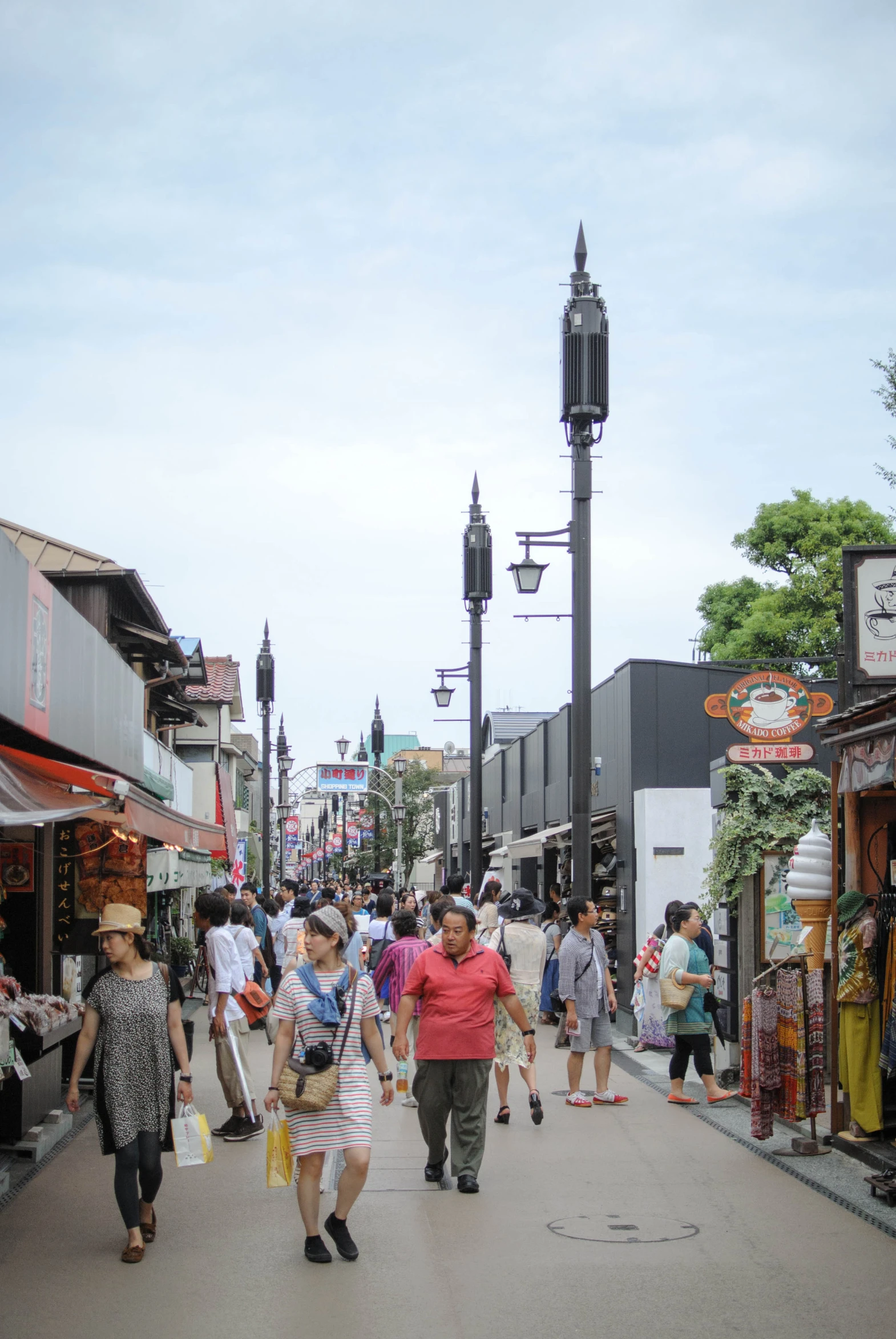 an image of people walking through the shops