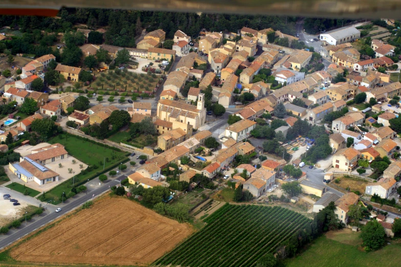 an aerial view of town with houses and fields