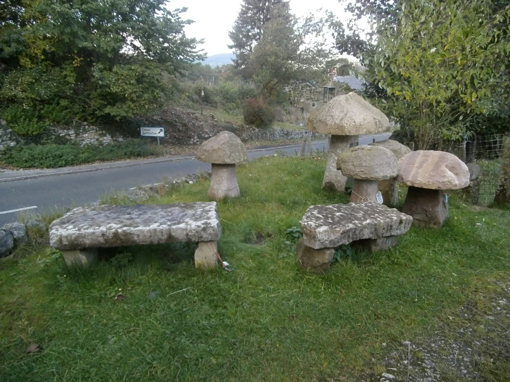 stone benches with big mushrooms made out of them