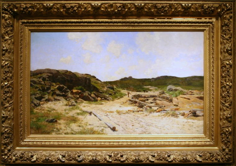 a painting of rocks, sand, and grass in a gold frame