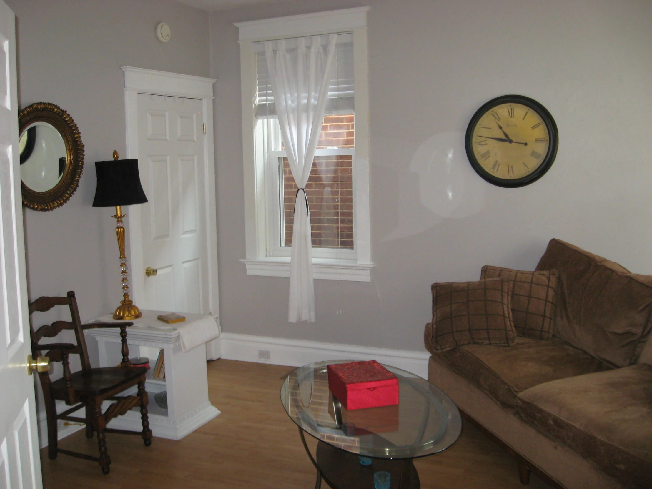 a living room filled with furniture and a wall clock