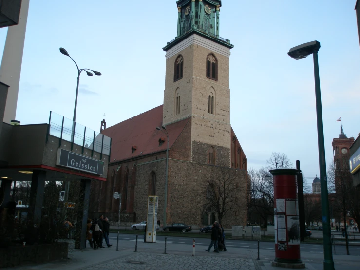 a tall clock tower sitting in the middle of a small town