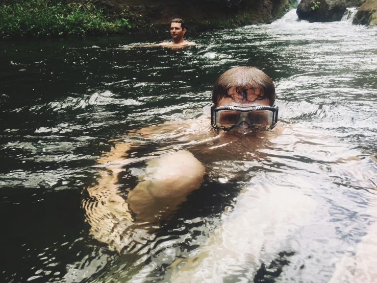 two men on a water sport device floating in the river