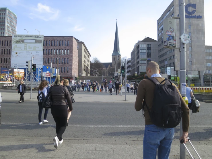 people on the road and walking with their luggage