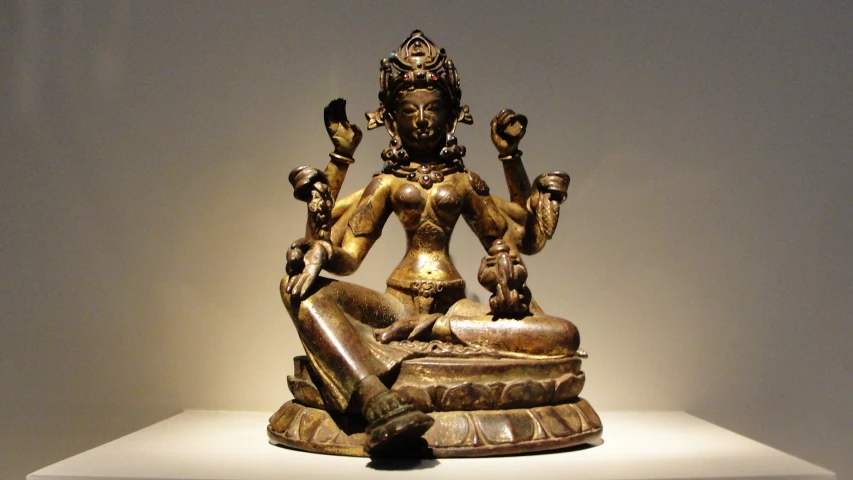 an indian statue that is in a white room