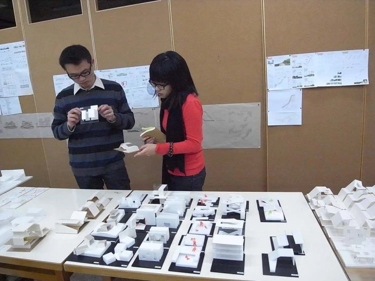 a man and woman looking at paper work