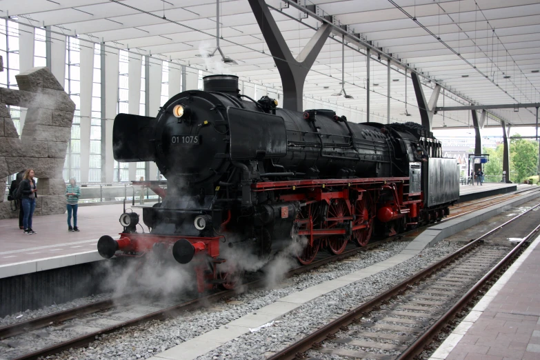 a large black train on display at the museum