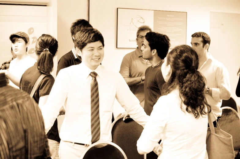 two women in business attire are holding hands and greeting each other