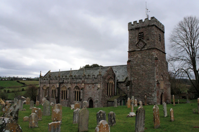 a gothic church with a graveyard at its foot