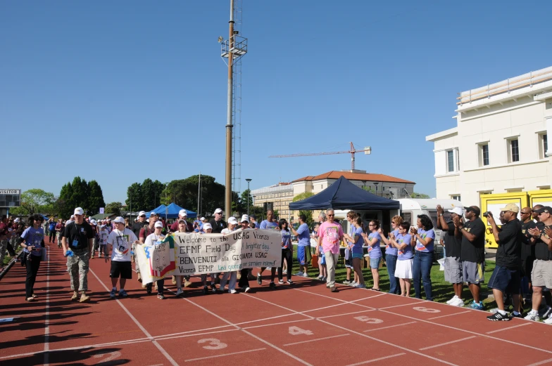 people with signs standing around in a large group