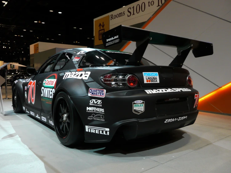 a sci - cross race car parked on display at a convention