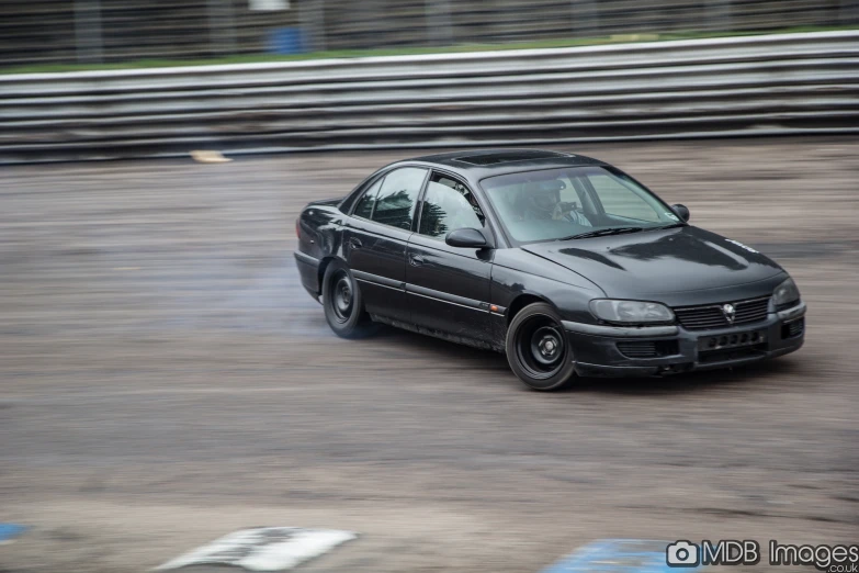 a car driving down a wet track in the rain