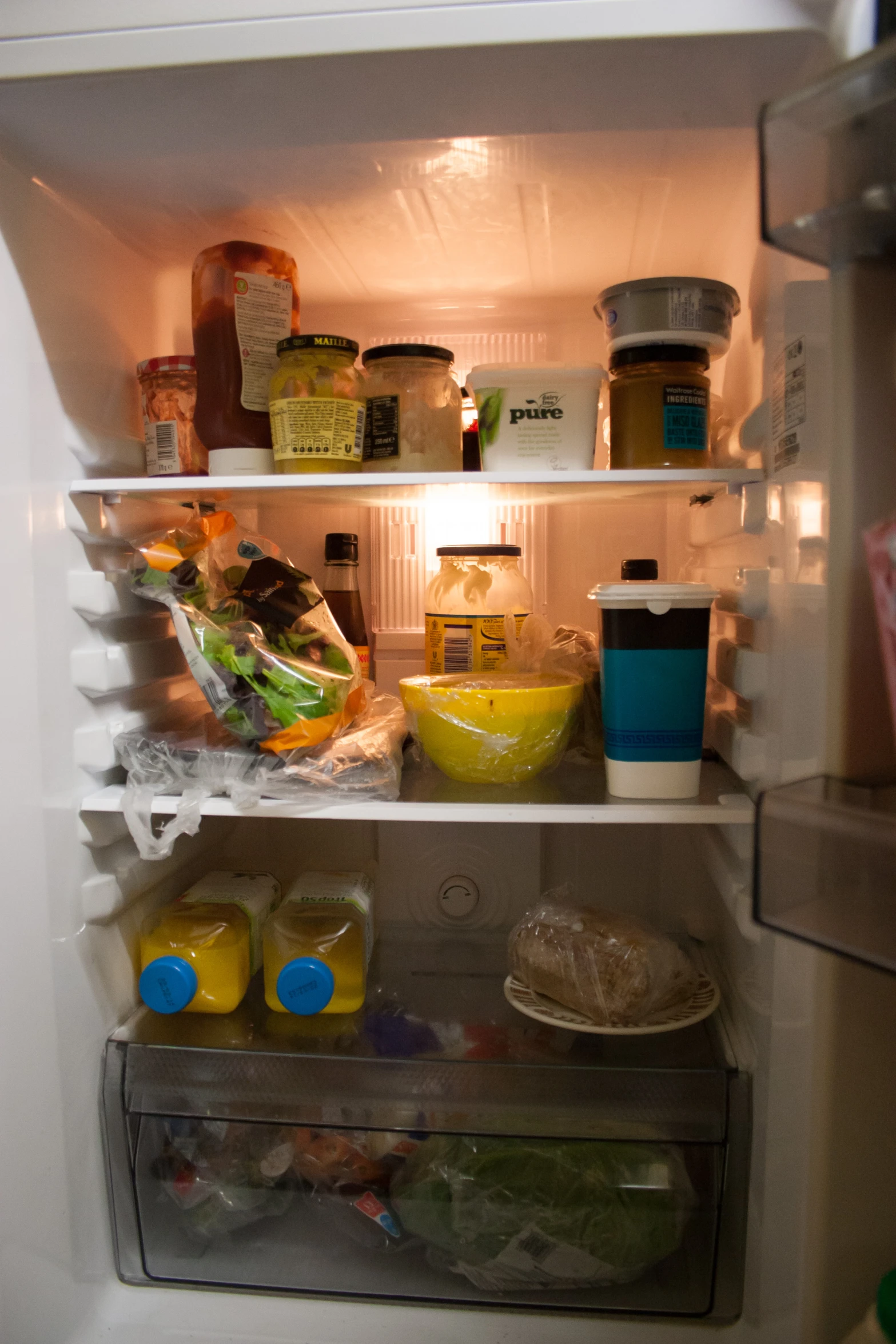 an open refrigerator showing all the food inside