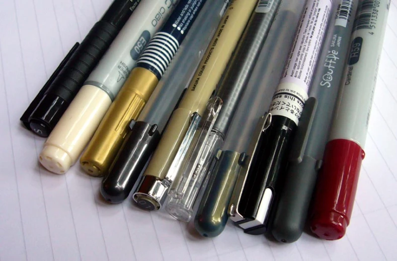 five different types of pens lined up in a row
