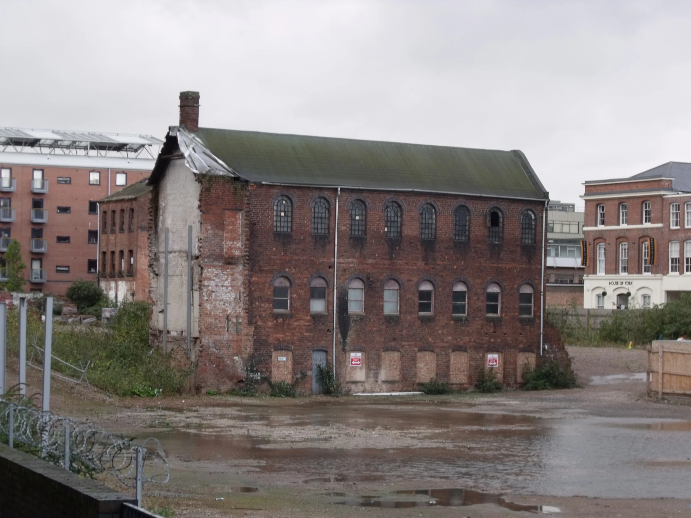 a large old building surrounded by flooded streets