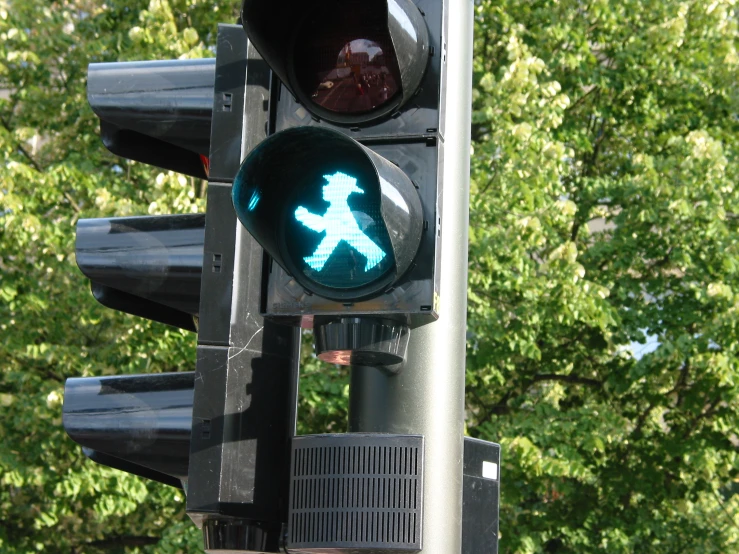 a walk signal that has been tagged with a sticker