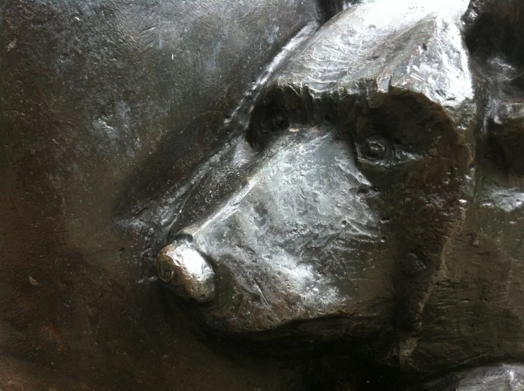 the bronze sculpture is of a dog's face