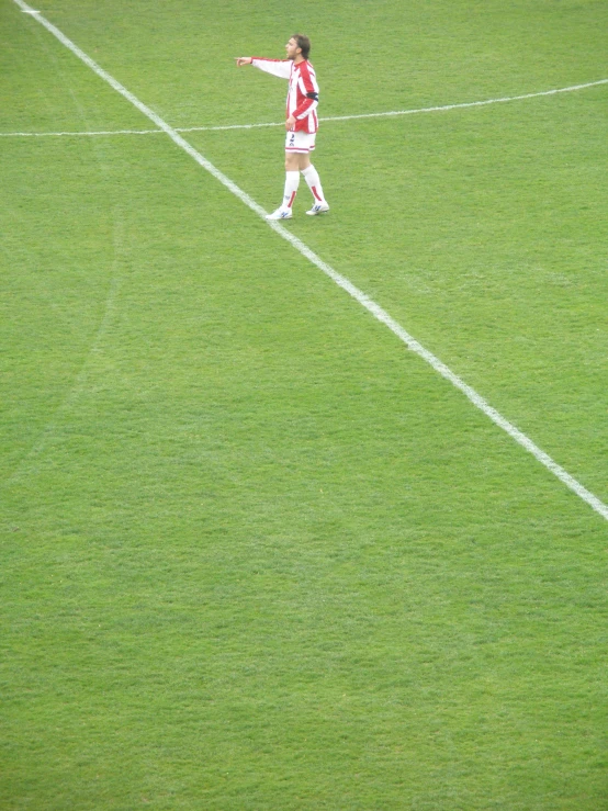 soccer player in motion on grassy field with ball