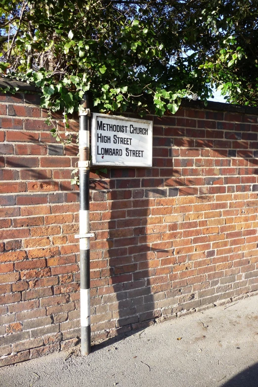 a brick wall with signs posted on it