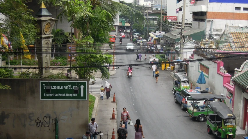 some people and some vehicles on the street