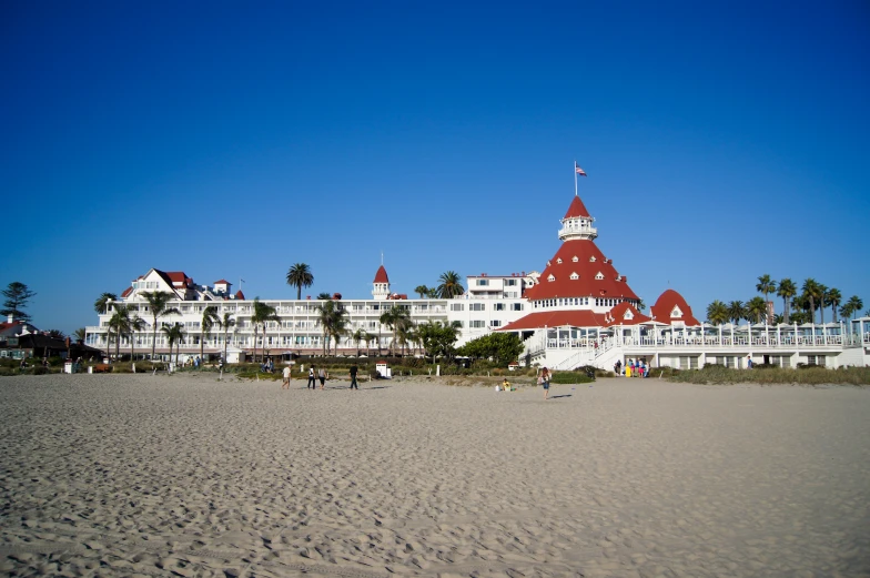 an image of a beach front building with people walking