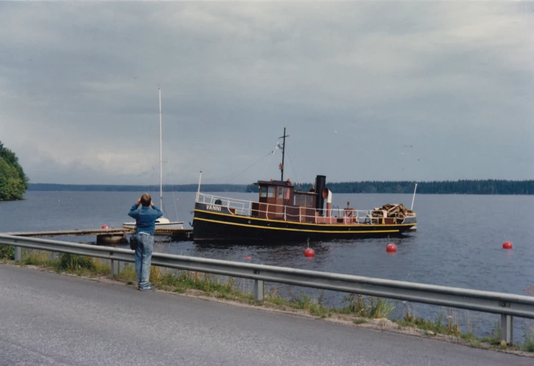 a woman taking a po on a waterway near a boat