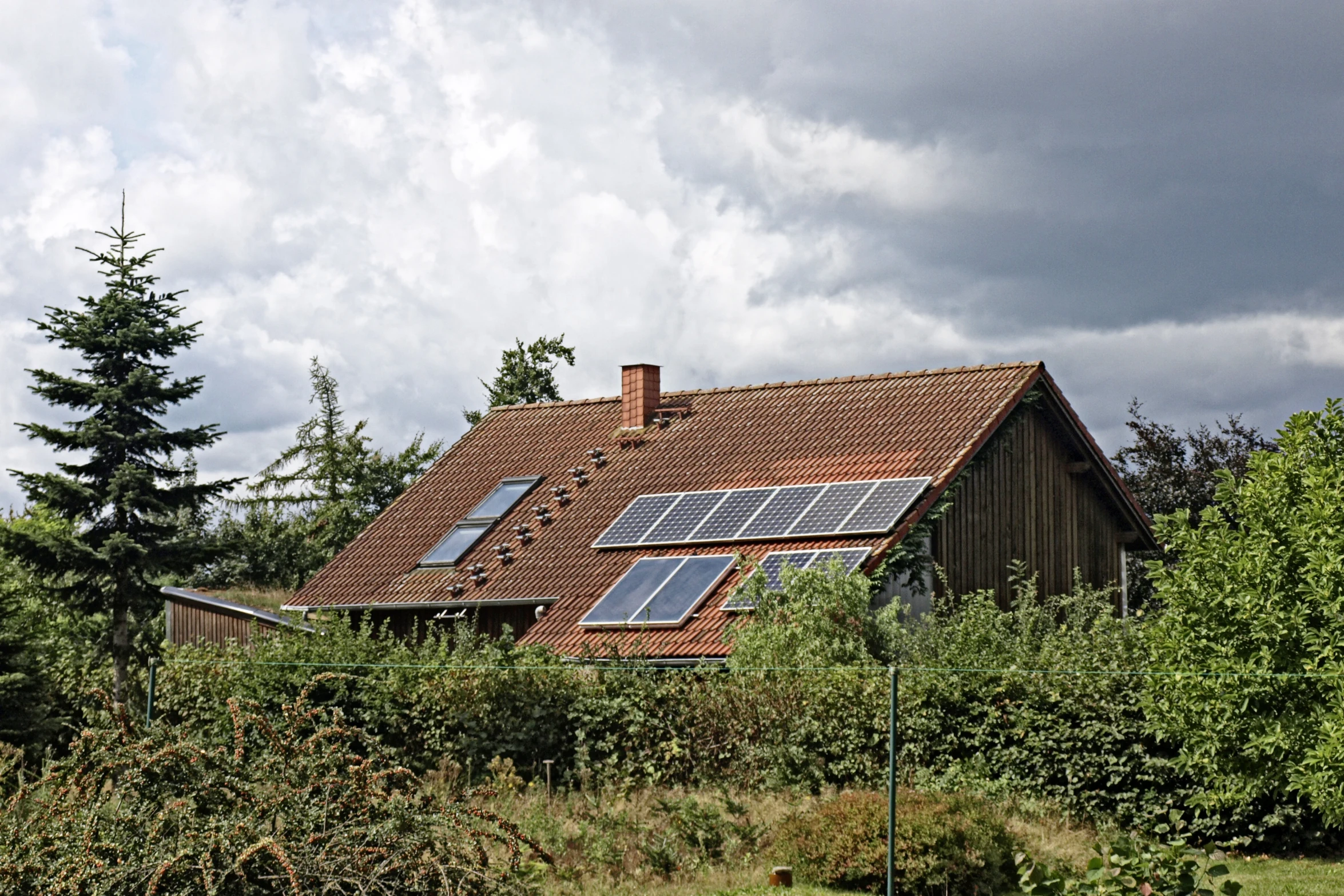 this is a house with many solar panels on it's roof