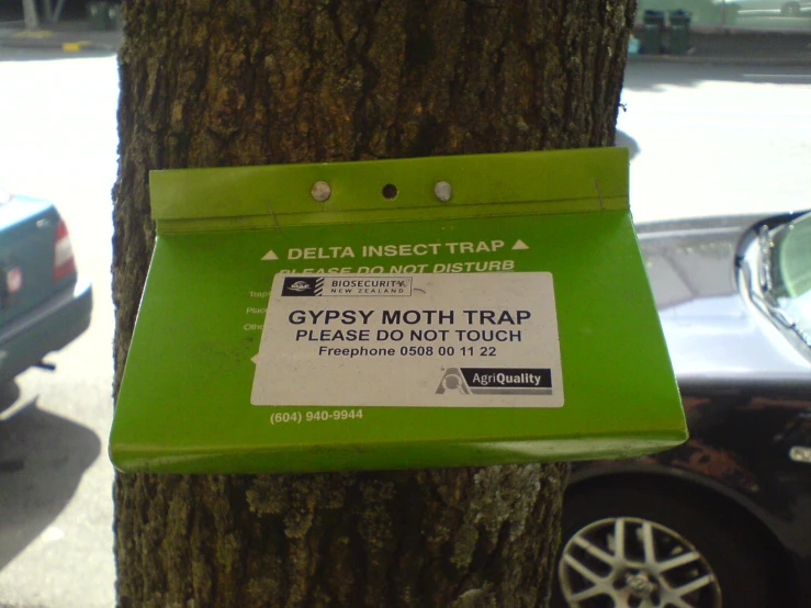 a close up of a street sign attached to a tree