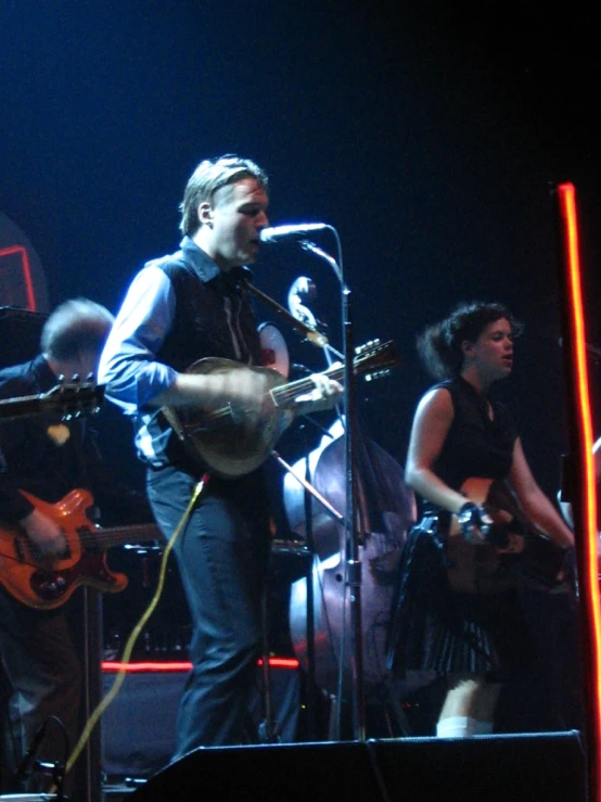 a man playing a guitar on stage