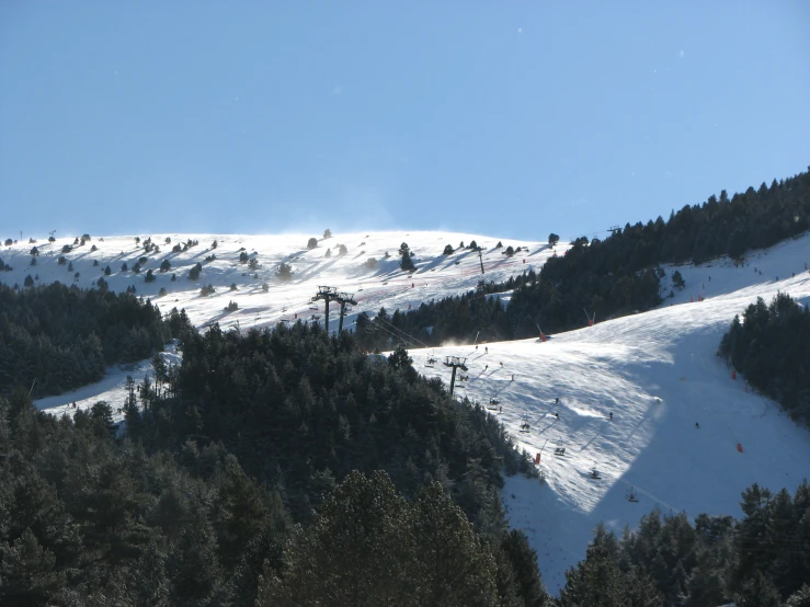 the mountain has two skiers on it as they go uphill