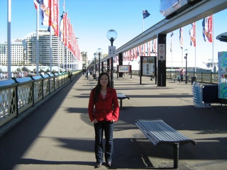 a woman standing in an area with some flags flying above