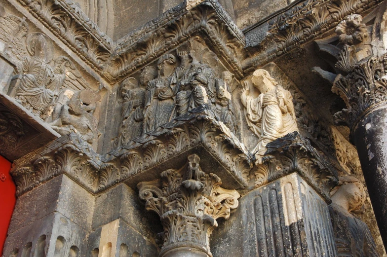 an ornate looking building with statues on the outside