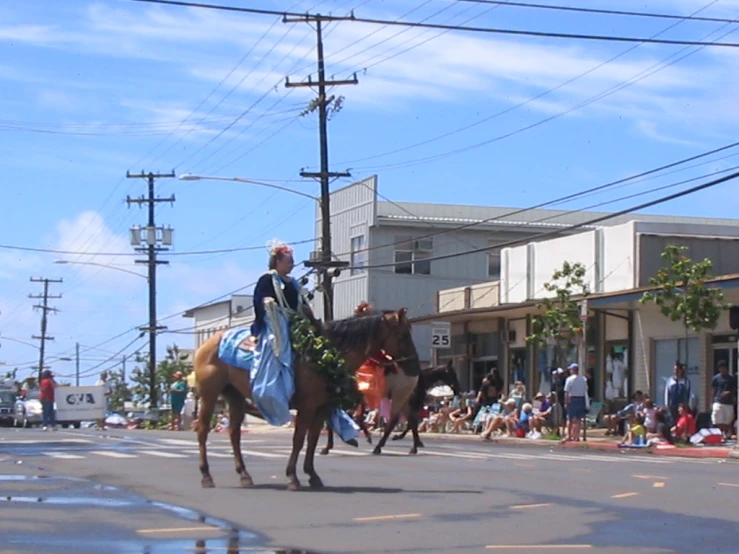 a woman is riding a horse down the street