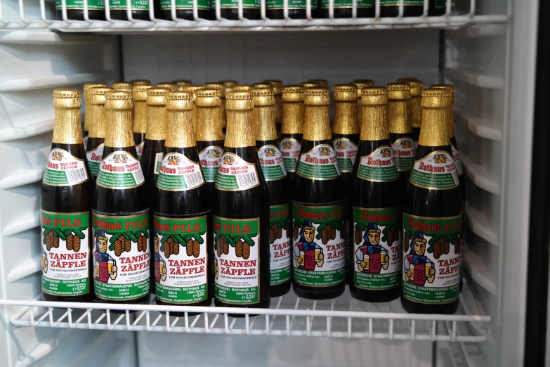 a refridgerator with beer bottles in each and a lot more bottles