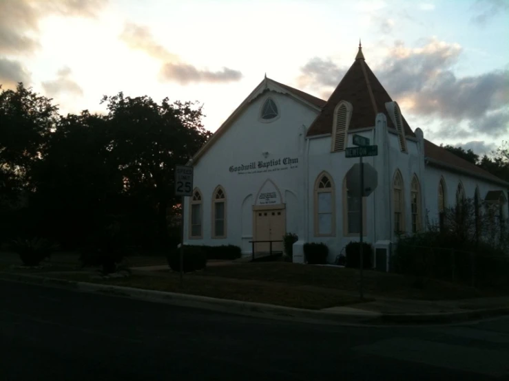 a small church sitting on the corner of a street